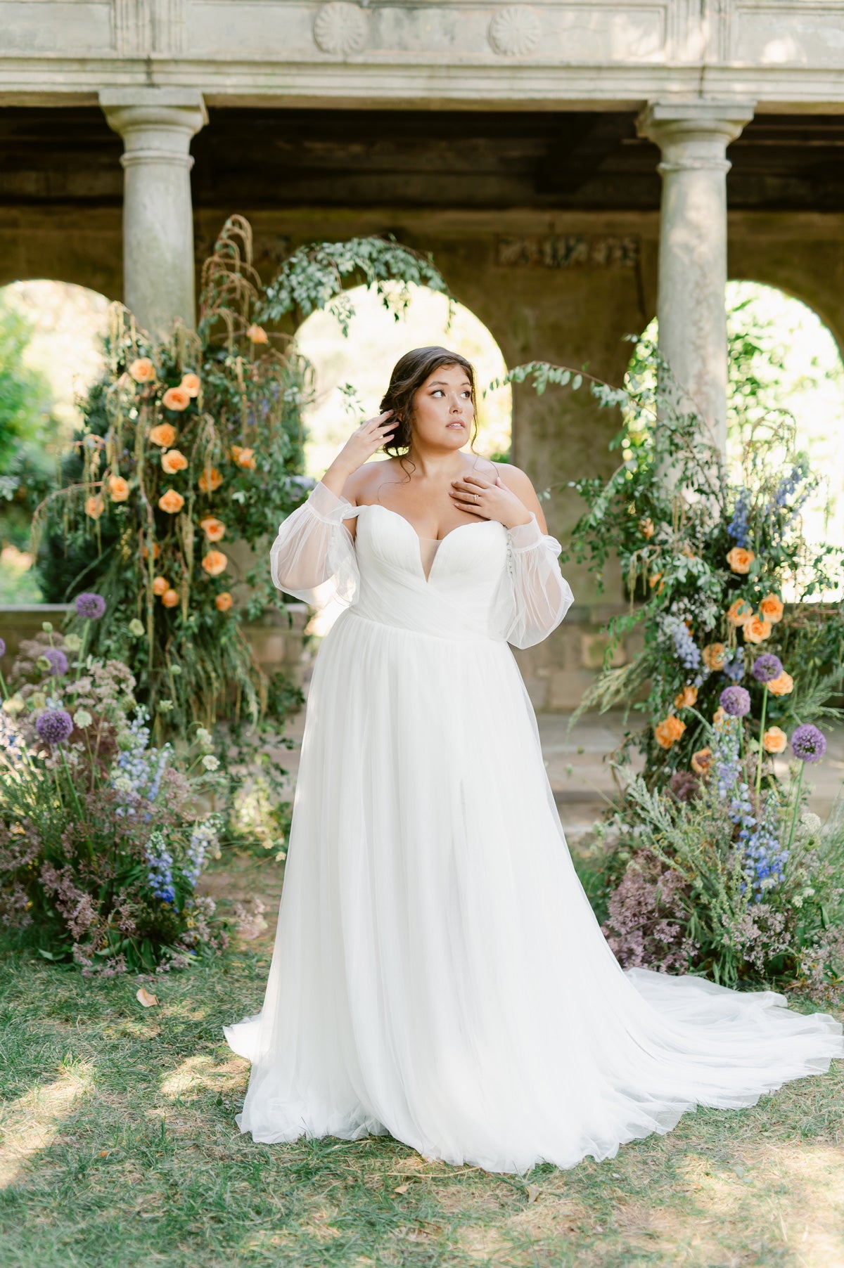 Woman in wedding dress standing in garden